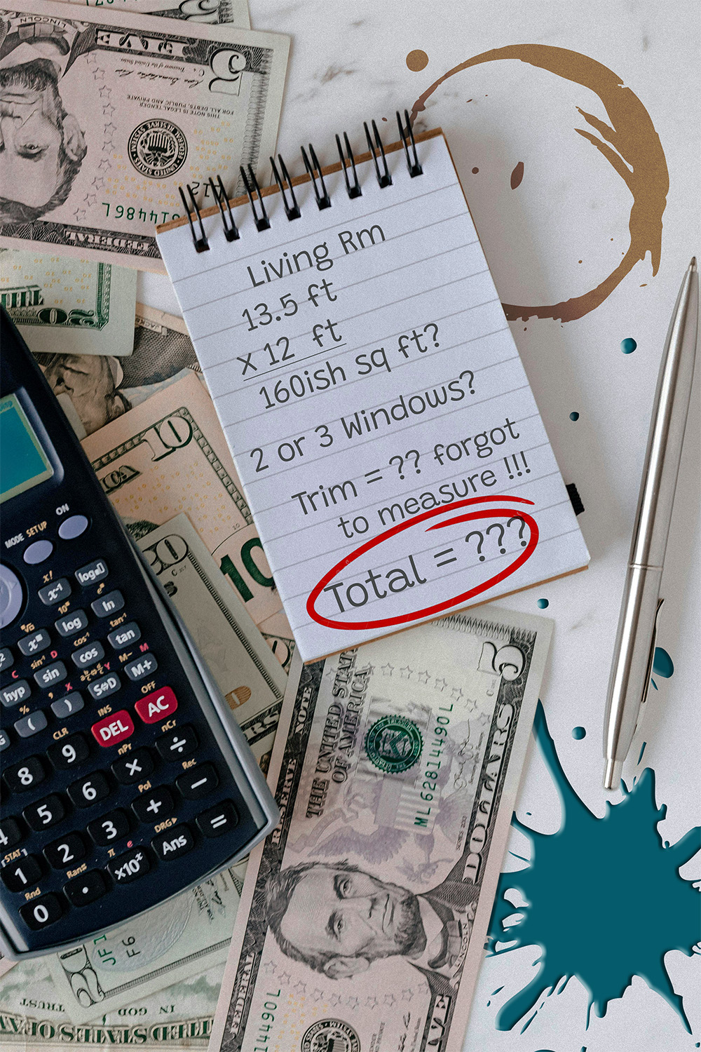 Notepad with half finished calculations next to a calculator and a pile of money on a dirty table